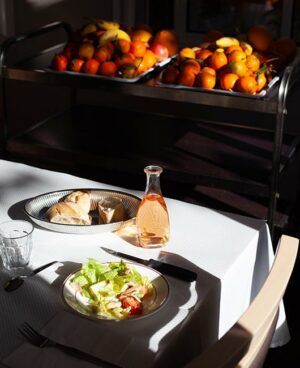 11Photo d'une table du restaurant de la maison de retraite à Marseille La Constance avec du vin une salade et du pain.